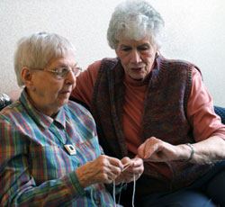 Volunteer Helping Resident Knit